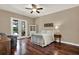 Cozy bedroom featuring hardwood floors, French doors, and a ceiling fan at 2614 Brookforest Dr, Wesley Chapel, FL 33544