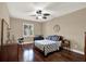 Bedroom with natural light, hardwood floors, and desk workstation at 2614 Brookforest Dr, Wesley Chapel, FL 33544