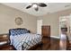 Charming bedroom offers dark hardwood floors and a ceiling fan at 2614 Brookforest Dr, Wesley Chapel, FL 33544