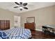 This bedroom includes a ceiling fan, hard wood floors, and an adjacent workstation at 2614 Brookforest Dr, Wesley Chapel, FL 33544