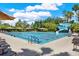 A sparkling community pool featuring lounge chairs, umbrellas, and a thrilling water slide, perfect for relaxation and recreation at 2614 Brookforest Dr, Wesley Chapel, FL 33544
