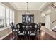 Sophisticated dining room with hardwood floors, plantation shutters, and elegant decor, perfect for formal dining at 2614 Brookforest Dr, Wesley Chapel, FL 33544