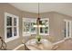 Bright dining area with a round table, seating for four, and sunlit windows with shutters at 2614 Brookforest Dr, Wesley Chapel, FL 33544