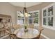 Charming breakfast nook with a round table, four chairs, and a decorative chandelier at 2614 Brookforest Dr, Wesley Chapel, FL 33544