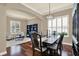 Elegant dining room featuring hardwood floors, plantation shutters, and stylish lighting, perfect for gatherings at 2614 Brookforest Dr, Wesley Chapel, FL 33544