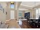 Inviting foyer with a staircase, arched doorway, and adjacent dining area with dark wood table at 2614 Brookforest Dr, Wesley Chapel, FL 33544