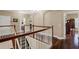 Upstairs hallway with hardwood floors, white railings and views of other rooms at 2614 Brookforest Dr, Wesley Chapel, FL 33544