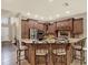 Spacious kitchen with custom wood cabinets, granite countertops, and a large island with seating at 2614 Brookforest Dr, Wesley Chapel, FL 33544