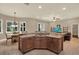 Spacious kitchen island with granite countertops, wooden cabinets, and adjacent dining area at 2614 Brookforest Dr, Wesley Chapel, FL 33544