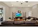 Comfortable living room with leather furniture, ceiling fan, and entertainment center at 2614 Brookforest Dr, Wesley Chapel, FL 33544