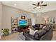 Comfortable living room with leather seating, media center, and decorative shelving at 2614 Brookforest Dr, Wesley Chapel, FL 33544