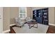 Inviting living room with hardwood floors, plantation shutters, and a stylish bookshelf, perfect for relaxing or entertaining at 2614 Brookforest Dr, Wesley Chapel, FL 33544