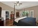 Inviting main bedroom featuring private balcony, ceiling fan, and ample closet space at 2614 Brookforest Dr, Wesley Chapel, FL 33544
