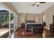 Spacious main bedroom with hardwood floors and a private balcony overlooking greenery at 2614 Brookforest Dr, Wesley Chapel, FL 33544