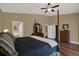 Comfortable main bedroom with hardwood floors and easy access to the ensuite bathroom at 2614 Brookforest Dr, Wesley Chapel, FL 33544