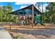 A shaded community playground with climbing structures, slides, and various play equipment, perfect for active  at 2614 Brookforest Dr, Wesley Chapel, FL 33544