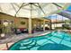 Beautiful pool and outdoor living space with a covered patio perfect for entertaining and enjoying the weather at 2614 Brookforest Dr, Wesley Chapel, FL 33544