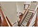 Elegant staircase with wood railings and carpeted steps leading to the lower level at 2614 Brookforest Dr, Wesley Chapel, FL 33544