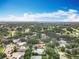 Picturesque overhead shot showing homes, a golf course, and mature trees in a well-established neighborhood on a sunny day at 2742 Sea Pines E Cir, Clearwater, FL 33761