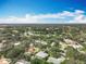 Expansive aerial view showcasing the lush, tree-filled neighborhood with well-manicured lawns and a golf course in the distance at 2742 Sea Pines E Cir, Clearwater, FL 33761