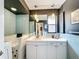 Bathroom with blue tiling, white cabinetry, and a jacuzzi tub at 2742 Sea Pines E Cir, Clearwater, FL 33761