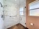Modern bathroom featuring a glass enclosed shower with marble tile and a window providing natural light at 2742 Sea Pines E Cir, Clearwater, FL 33761