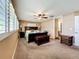 Bedroom with neutral walls, ceiling fan, and ensuite bathroom entrance at 2742 Sea Pines E Cir, Clearwater, FL 33761