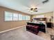 Primary bedroom features a ceiling fan, neutral paint, and a decorative wooden chest at the foot of the bed at 2742 Sea Pines E Cir, Clearwater, FL 33761