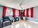 Bonus room with red curtains, fan, hardwood flooring, and comfortable seating at 2742 Sea Pines E Cir, Clearwater, FL 33761