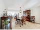 Open dining room featuring a wooden table and hutch, chandelier, and access to the kitchen at 2742 Sea Pines E Cir, Clearwater, FL 33761