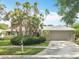 Charming single-story home with a well-manicured lawn, complemented by mature trees and lush landscaping at 2742 Sea Pines E Cir, Clearwater, FL 33761