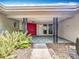 Inviting front entrance featuring a vibrant red door, decorative pillars, and tiled patio area at 2742 Sea Pines E Cir, Clearwater, FL 33761