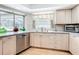 Kitchen featuring stainless steel dishwasher and sink under a window with plenty of cabinet space at 2742 Sea Pines E Cir, Clearwater, FL 33761