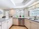 Bright kitchen featuring stainless steel appliances, double sink, and countertop under a window at 2742 Sea Pines E Cir, Clearwater, FL 33761