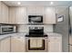 Kitchen with stainless steel appliances, including an oven, microwave, and a refrigerator at 2742 Sea Pines E Cir, Clearwater, FL 33761