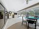 Screened lanai with ceiling fans, dining area, and access to a pool with a waterslide for outdoor fun at 2742 Sea Pines E Cir, Clearwater, FL 33761