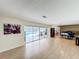 Unstaged living room with pool view, natural light, and hardwood flooring at 2742 Sea Pines E Cir, Clearwater, FL 33761