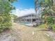 Backyard oasis featuring a screened-in pool area with a slide and lush greenery at 2742 Sea Pines E Cir, Clearwater, FL 33761