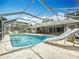 Screened-in pool with a slide, backyard views, and outdoor seating at 2742 Sea Pines E Cir, Clearwater, FL 33761