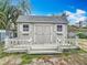 Exterior view of the charming shed with windows, double doors, and a small deck at 2742 Sea Pines E Cir, Clearwater, FL 33761