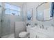 Stylish bathroom featuring tile flooring, a glass-enclosed shower, and decorative artwork at 2750 Reserve Ct # 101, Dunedin, FL 34698