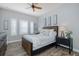 Charming bedroom featuring a wooden bed frame, decorative lamps, and window with decorative shutters at 2750 Reserve Ct # 101, Dunedin, FL 34698