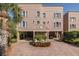 Inviting condo exterior with covered parking, manicured landscaping, and charming architectural details at 2750 Reserve Ct # 101, Dunedin, FL 34698