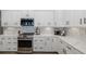Well-appointed kitchen with stainless steel appliances, white countertops, and stylish backsplash for a modern look at 2750 Reserve Ct # 101, Dunedin, FL 34698