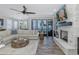 Inviting living room features a cozy fireplace, water views, and comfortable seating, creating an ideal relaxation space at 2750 Reserve Ct # 101, Dunedin, FL 34698