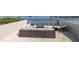 Relaxing rooftop deck with stylish outdoor seating, fire pit, and panoramic water views at 2750 Reserve Ct # 101, Dunedin, FL 34698
