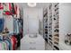 Spacious walk-in closet with custom shelving and drawers provides ample storage for clothes, shoes, and accessories at 2750 Reserve Ct # 101, Dunedin, FL 34698