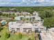 Scenic aerial view of multi-Gathering housing community with pool, tennis court, mature trees, and ample parking at 2840 Somerset Park Dr # 203, Tampa, FL 33613