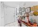 Hallway features white tile flooring, closet, and a console table decorated with flowers and art at 2840 Somerset Park Dr # 203, Tampa, FL 33613