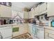 A functional kitchen with white appliances and cabinets with a view to the back yard at 2840 Somerset Park Dr # 203, Tampa, FL 33613